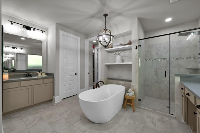 bathroom with separate shower and tub, a chandelier, and vanity