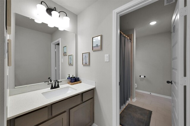 bathroom with tile patterned floors, toilet, and vanity