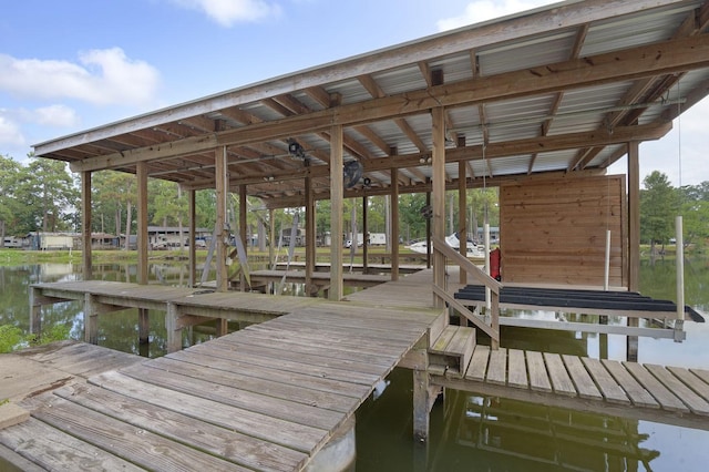 dock area with a water view and boat lift