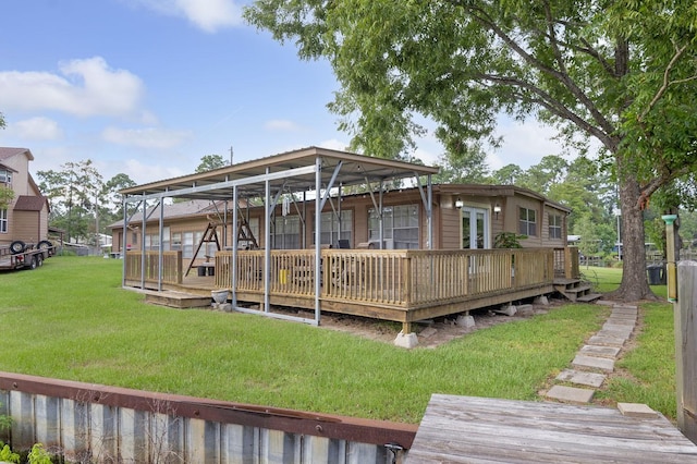 back of property with a deck and a yard