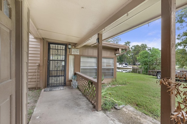 doorway to property featuring a lawn