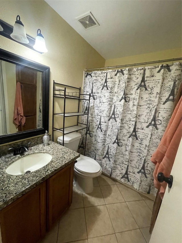 bathroom with tile patterned flooring, vanity, and toilet