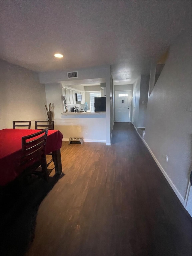 interior space with hardwood / wood-style flooring and a textured ceiling