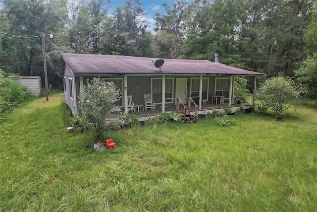 view of front of home with a front yard and a porch