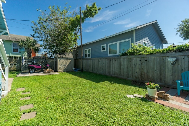 view of yard with a shed and a patio area