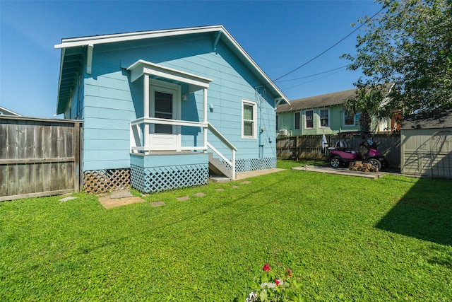 rear view of property featuring a yard