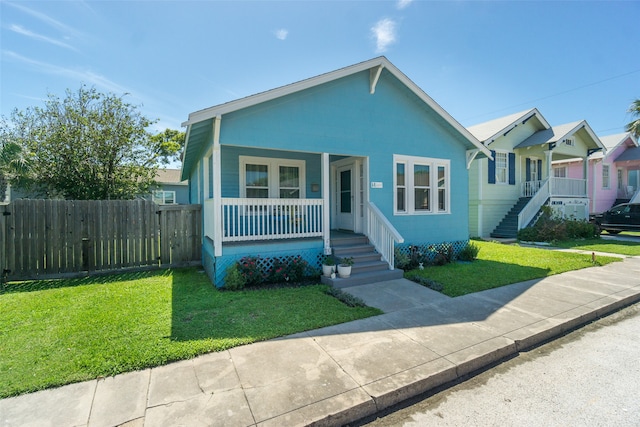 view of front of home featuring covered porch and a front lawn