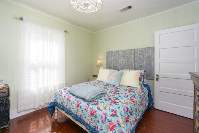 bedroom featuring ornamental molding and dark wood-type flooring