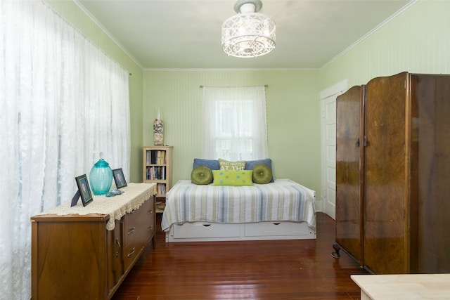 bedroom with crown molding and dark hardwood / wood-style flooring