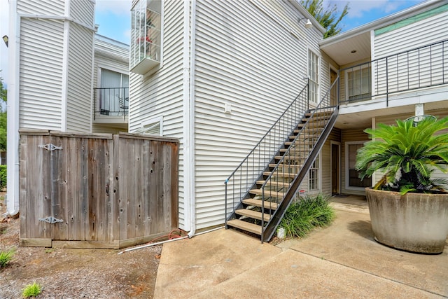 view of side of home featuring a patio and a balcony