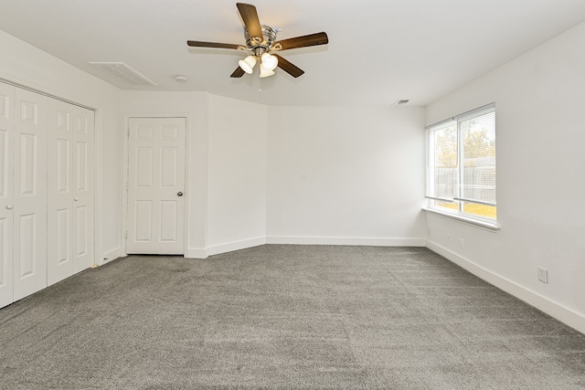 unfurnished room featuring carpet and ceiling fan