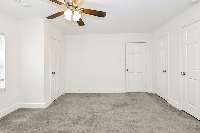 empty room with light colored carpet and ceiling fan