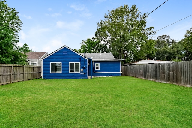 rear view of house with a lawn