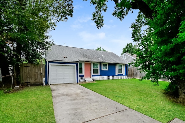 ranch-style house featuring a front yard and a garage