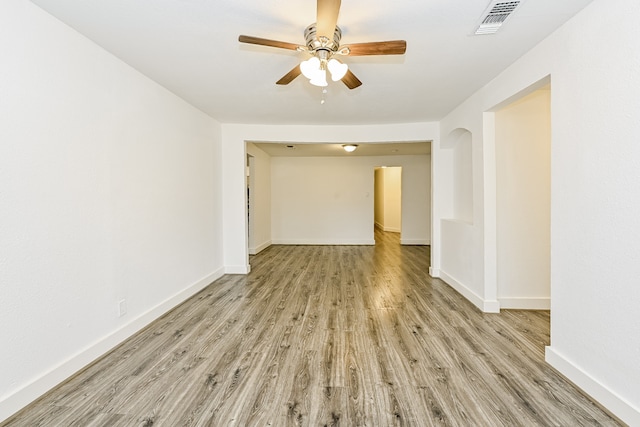 empty room featuring ceiling fan and light hardwood / wood-style flooring