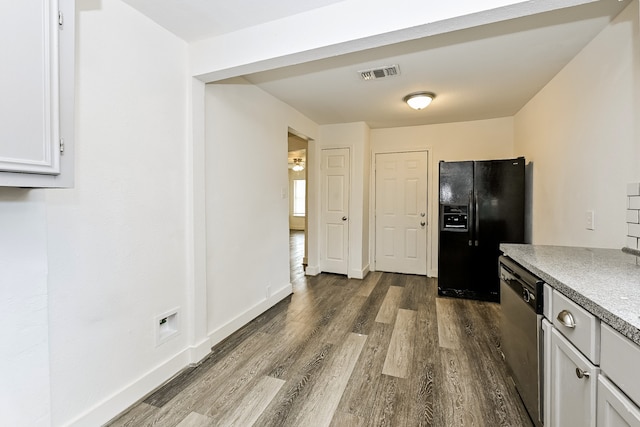 kitchen with dishwasher, hardwood / wood-style floors, and black fridge with ice dispenser