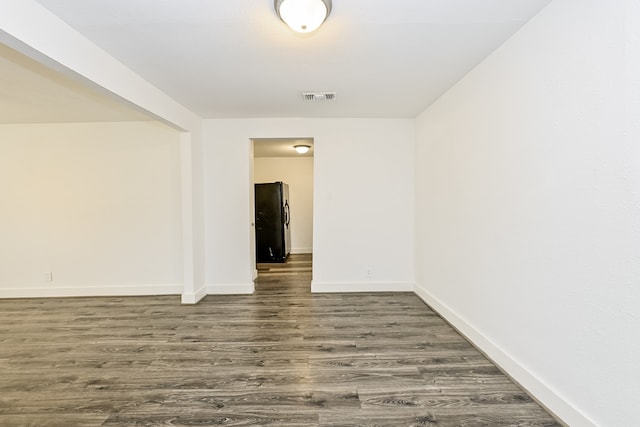 empty room with dark hardwood / wood-style floors