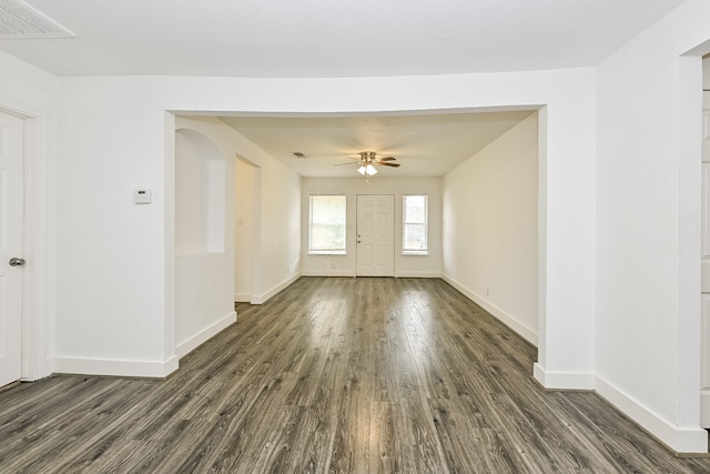 interior space with dark wood-type flooring and ceiling fan