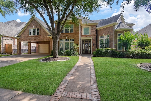 view of front of house featuring a garage and a front lawn