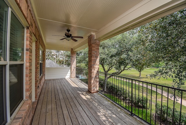 wooden deck featuring ceiling fan