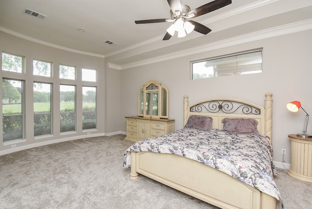 carpeted bedroom with ceiling fan and ornamental molding