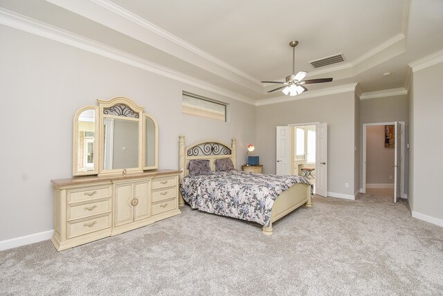 bedroom featuring crown molding, light colored carpet, ceiling fan, and a raised ceiling