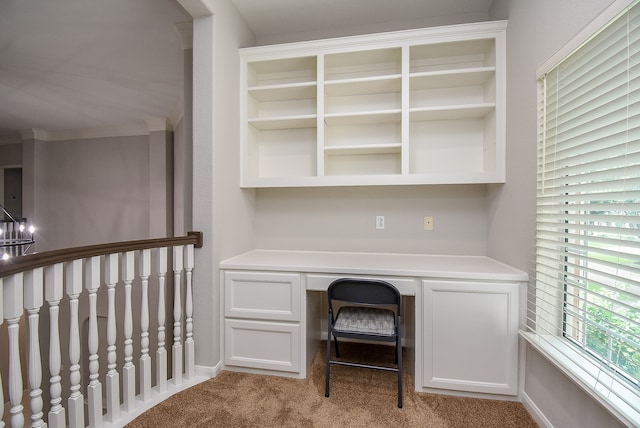 unfurnished office featuring a chandelier and light colored carpet