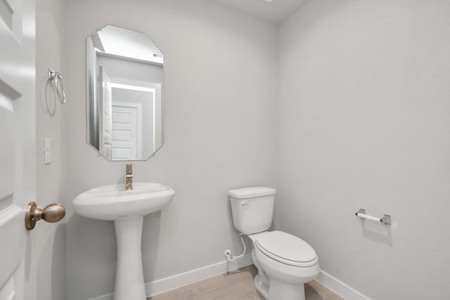bathroom featuring toilet and sink