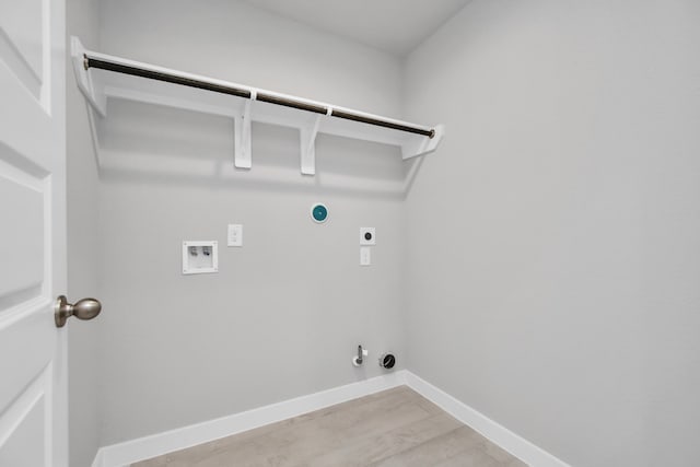 laundry room featuring electric dryer hookup, hookup for a gas dryer, light hardwood / wood-style flooring, and washer hookup