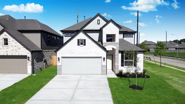 view of front of house featuring a garage and a front lawn