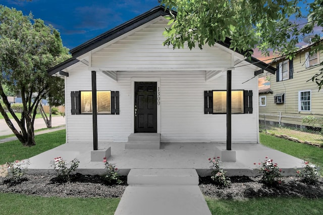 view of front of house featuring entry steps and fence