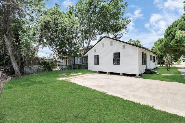 exterior space with driveway and a lawn