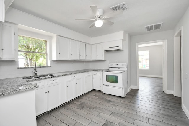 kitchen with electric stove, visible vents, a sink, and under cabinet range hood