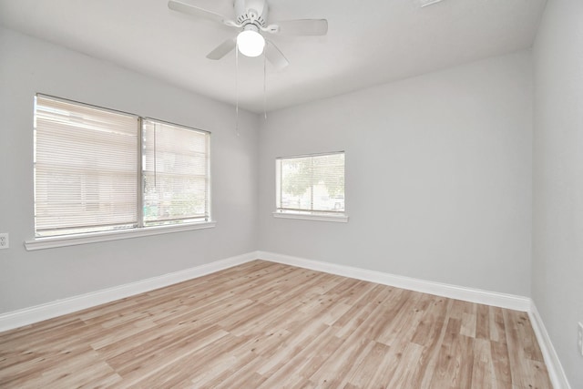 unfurnished room featuring light wood-style floors, a ceiling fan, and baseboards