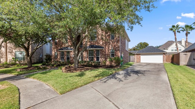 view of front of house with a front yard and a garage