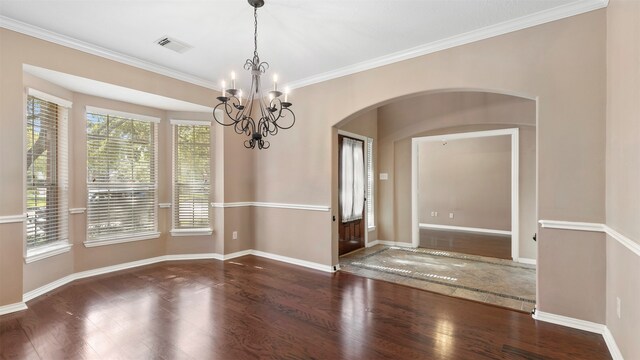 interior space featuring ornamental molding, dark hardwood / wood-style floors, and an inviting chandelier