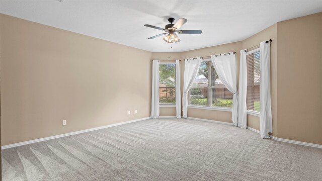 carpeted empty room with ceiling fan