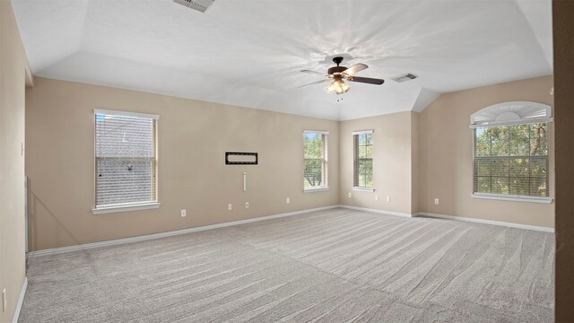 empty room with ceiling fan, light carpet, and vaulted ceiling