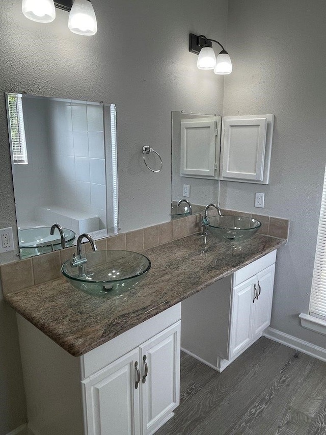 bathroom featuring a bathtub, vanity, and hardwood / wood-style floors