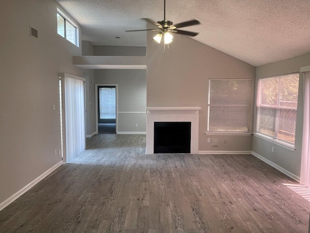 unfurnished living room with a textured ceiling, dark wood-type flooring, ceiling fan, and a fireplace