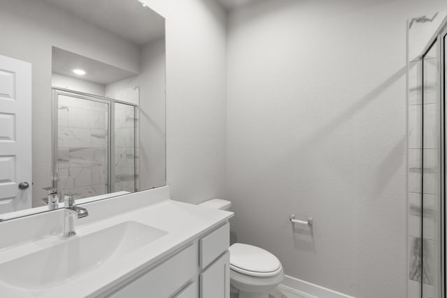 bathroom with vanity, toilet, and walk in shower