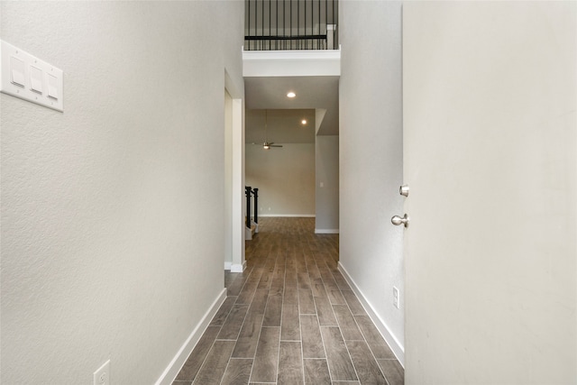 hall featuring dark hardwood / wood-style floors and a high ceiling