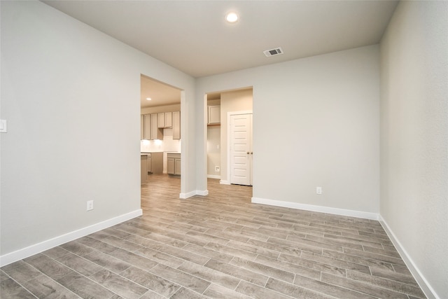 spare room with light wood-type flooring