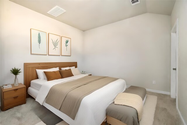 carpeted bedroom with lofted ceiling