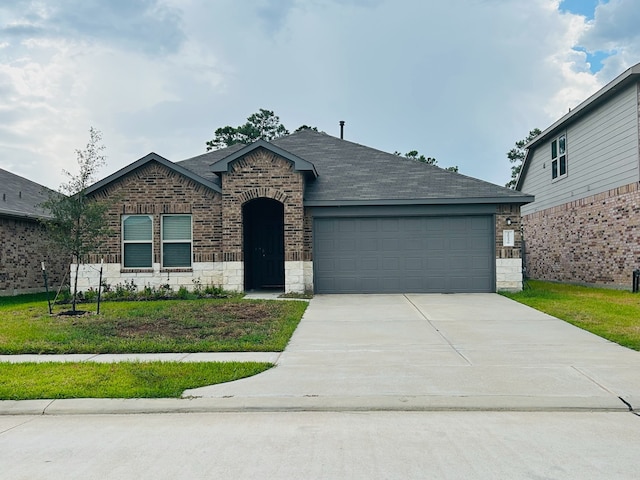 view of front facade with a garage and a front yard