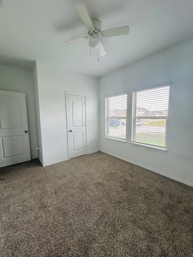 unfurnished bedroom with carpet flooring and ceiling fan