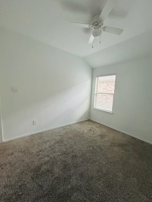 carpeted empty room with ceiling fan, a textured ceiling, and vaulted ceiling