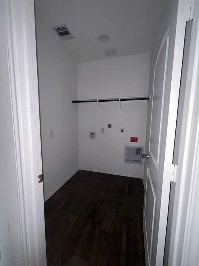 laundry room with dark wood-type flooring, washer hookup, hookup for an electric dryer, gas dryer hookup, and laundry area