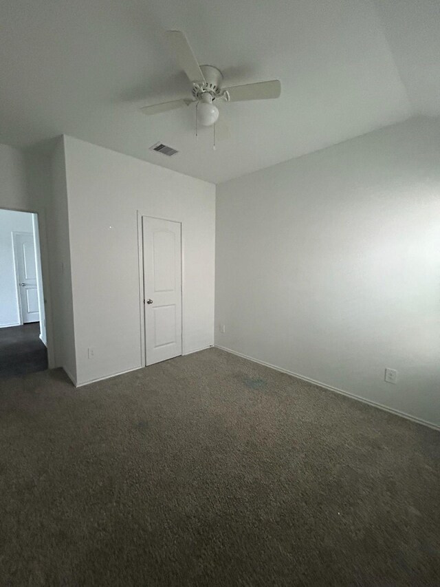 carpeted spare room with ceiling fan