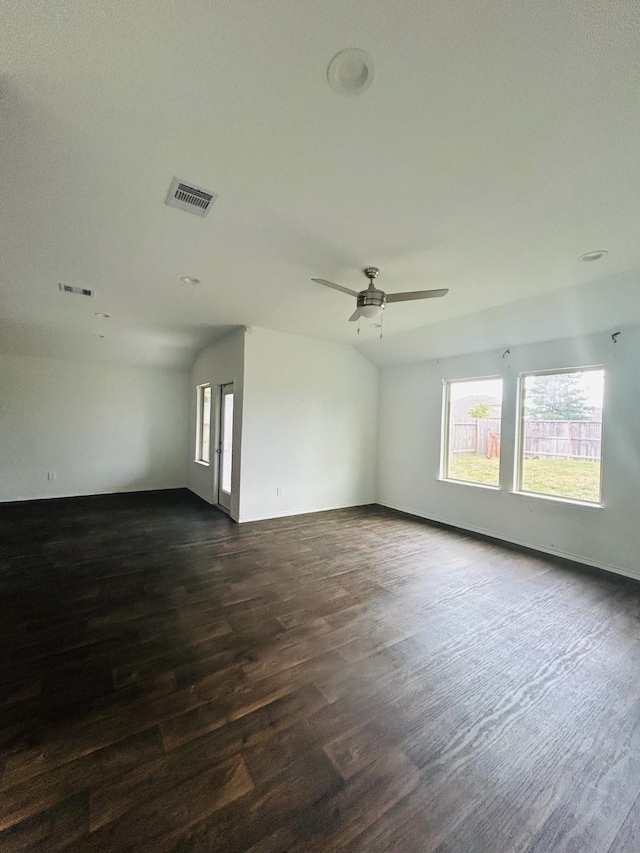 spare room featuring visible vents, baseboards, dark wood-type flooring, and a ceiling fan